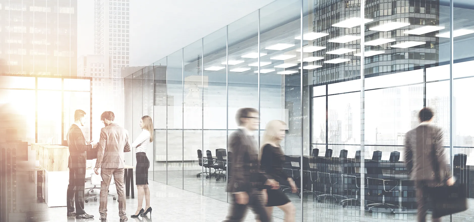 A busy corporate office with tall glass walls, motion-blurred professionals, and a visible conference room in bright lighting.